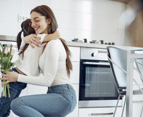 photo-of-woman-hugging-her-child-while-holding-tulips-4149006